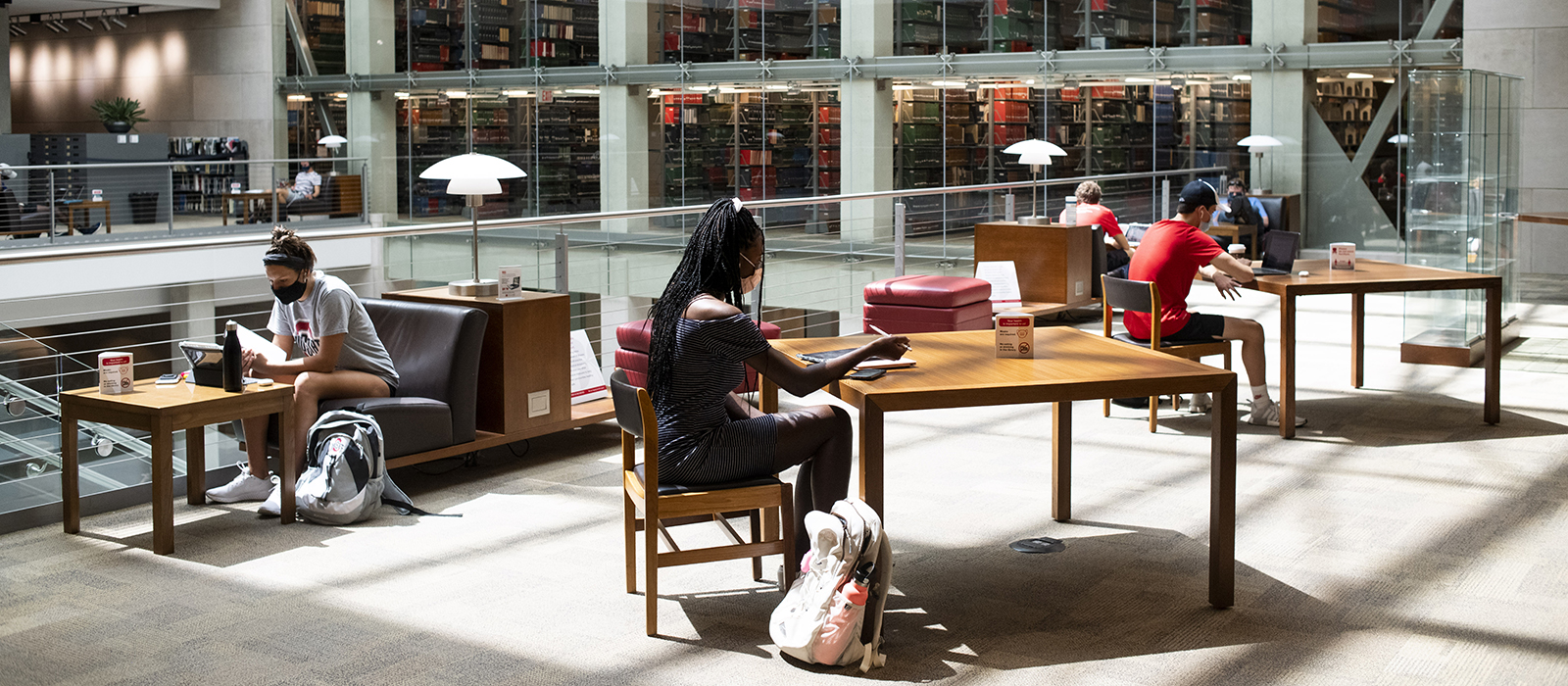 Students wearing protective masks study inside of the Thompson Library on the first day of classes at Ohio State University.