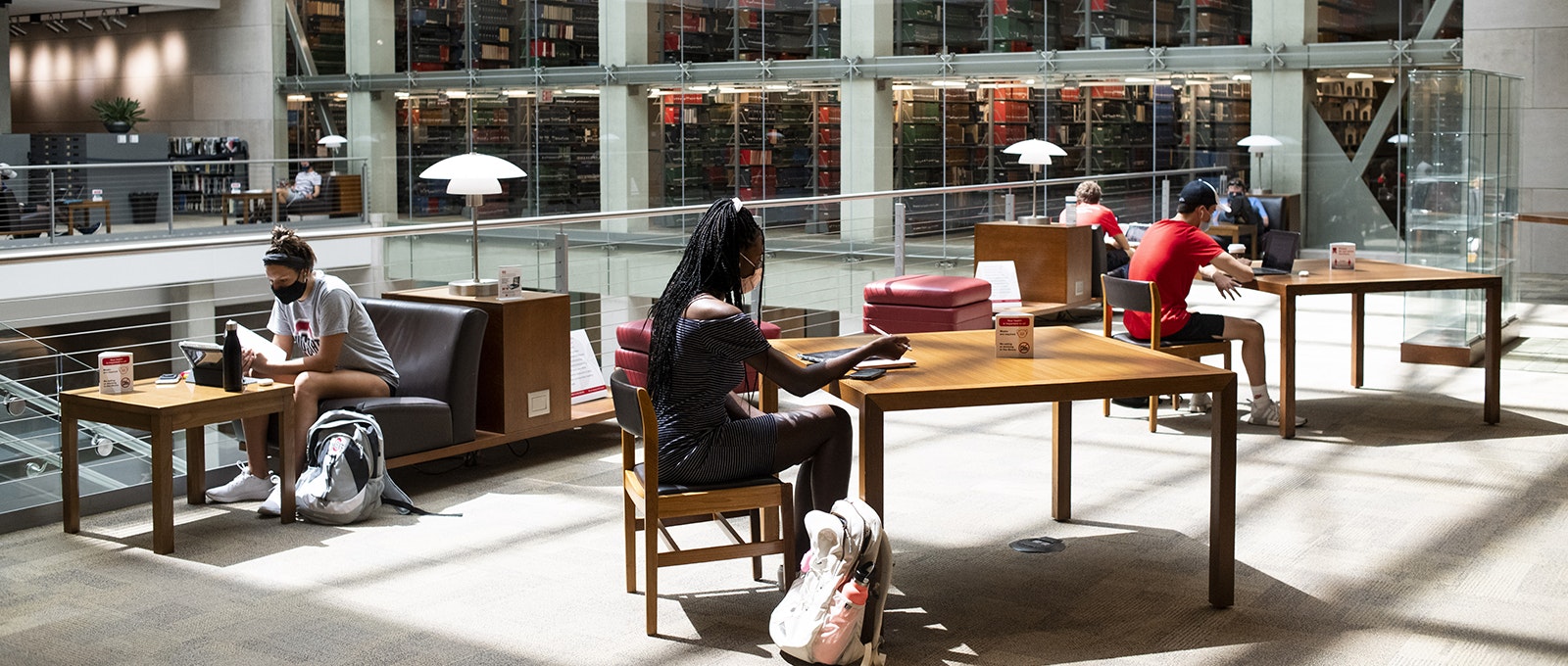 Students wearing protective masks study inside of the Thompson Library on the first day of classes at Ohio State University.