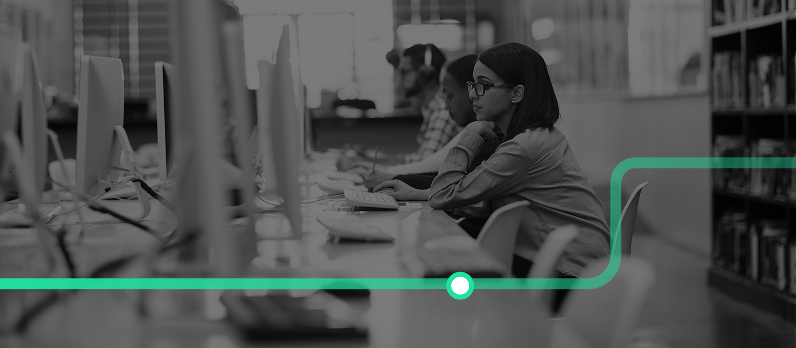 Shot of a group of university students working on computers in the library at campus