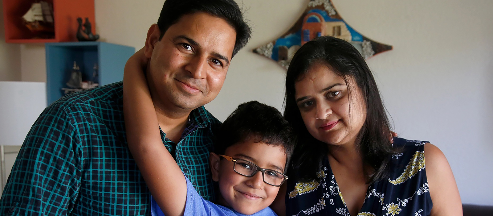 A photo of Kriti, an H-4 visa holder, with her husband and son.