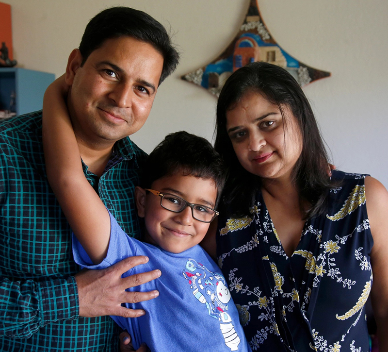 A photo of an H-4 visa holder with her husband and son.