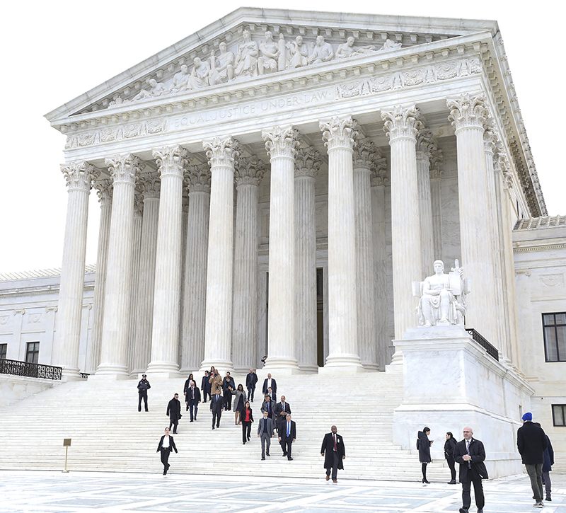 A group of people walks down the steps of the Supreme Court after a hearing on the DACA policy.