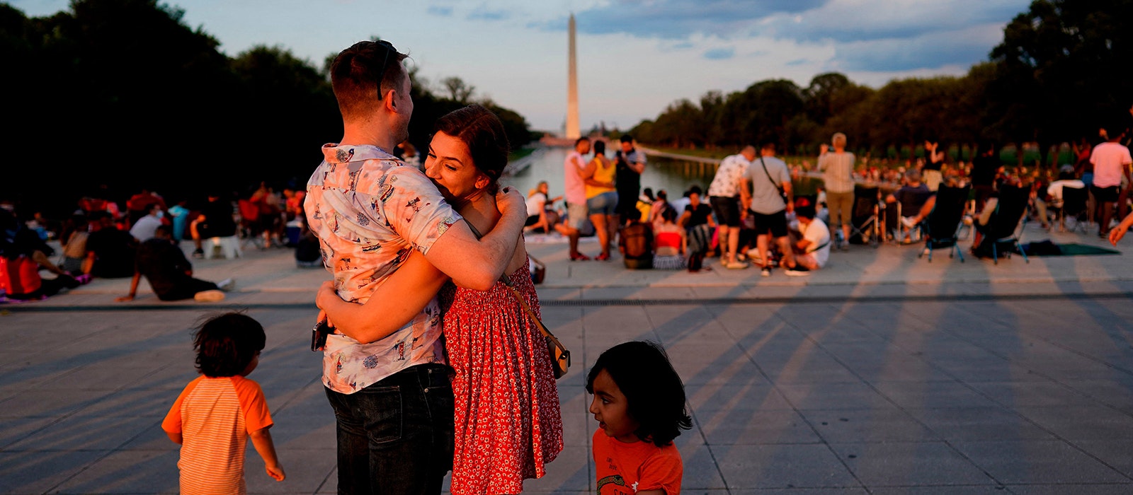 A couple hugs as visitors wait prior to watching the Independence Day fireworks display near the Lincoln Memorial on the National Mall on July 4, 2021 in Washington, DC.