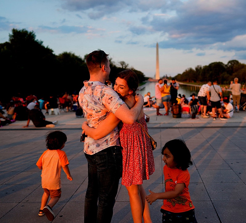 A couple hugs as visitors wait prior to watching the Independence Day fireworks display near the Lincoln Memorial on the National Mall on July 4, 2021 in Washington, DC.